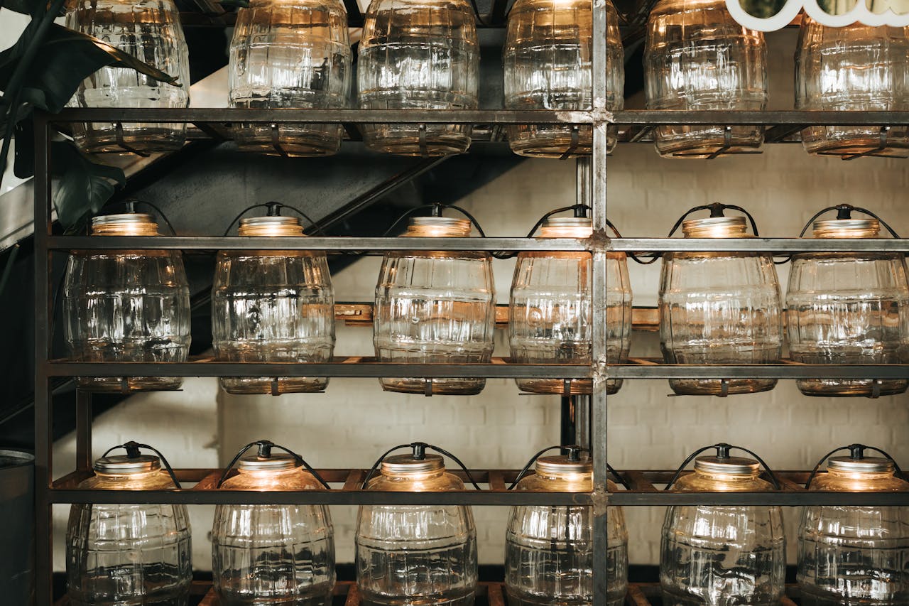 Mastering the First Impression: Your intriguing post title goes here Rows of empty glass jars on metal shelves in a dimly lit environment.